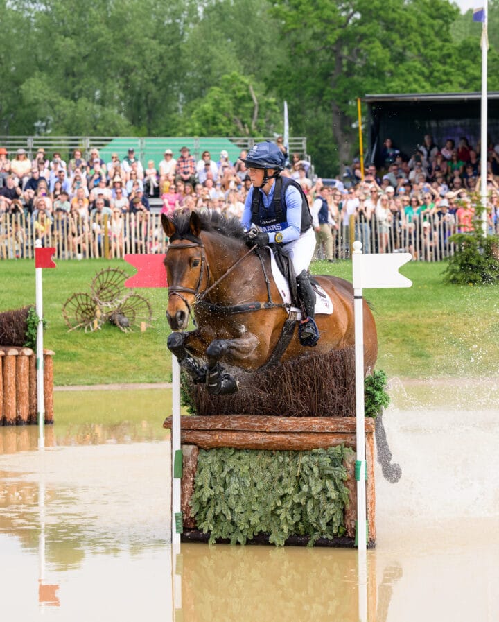 Ros Canter and LORDSHIPS GRAFFALO (Walter) jumping through the lake at Badminton Horse Trials 2026. Copyright Nico Morgan