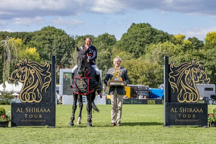 Robert Whitaker is presented with the Al Shira'aa King George V Gold Cup by BHS President Martin Clunes